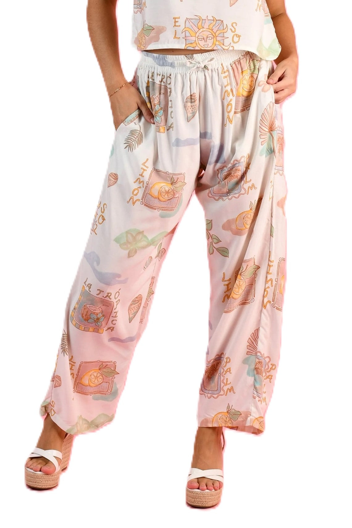Woman wearing the Yacht Long pants in Zesty postcoard a full length relaxed fit pant with elasticated waist and fun print in blue, green, white and yellow by Go Girl.