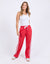 Lady wearing Foxwood's red Power Pants / jogger bottoms with White side stripes, 100% lightweight Cotton with a full length.