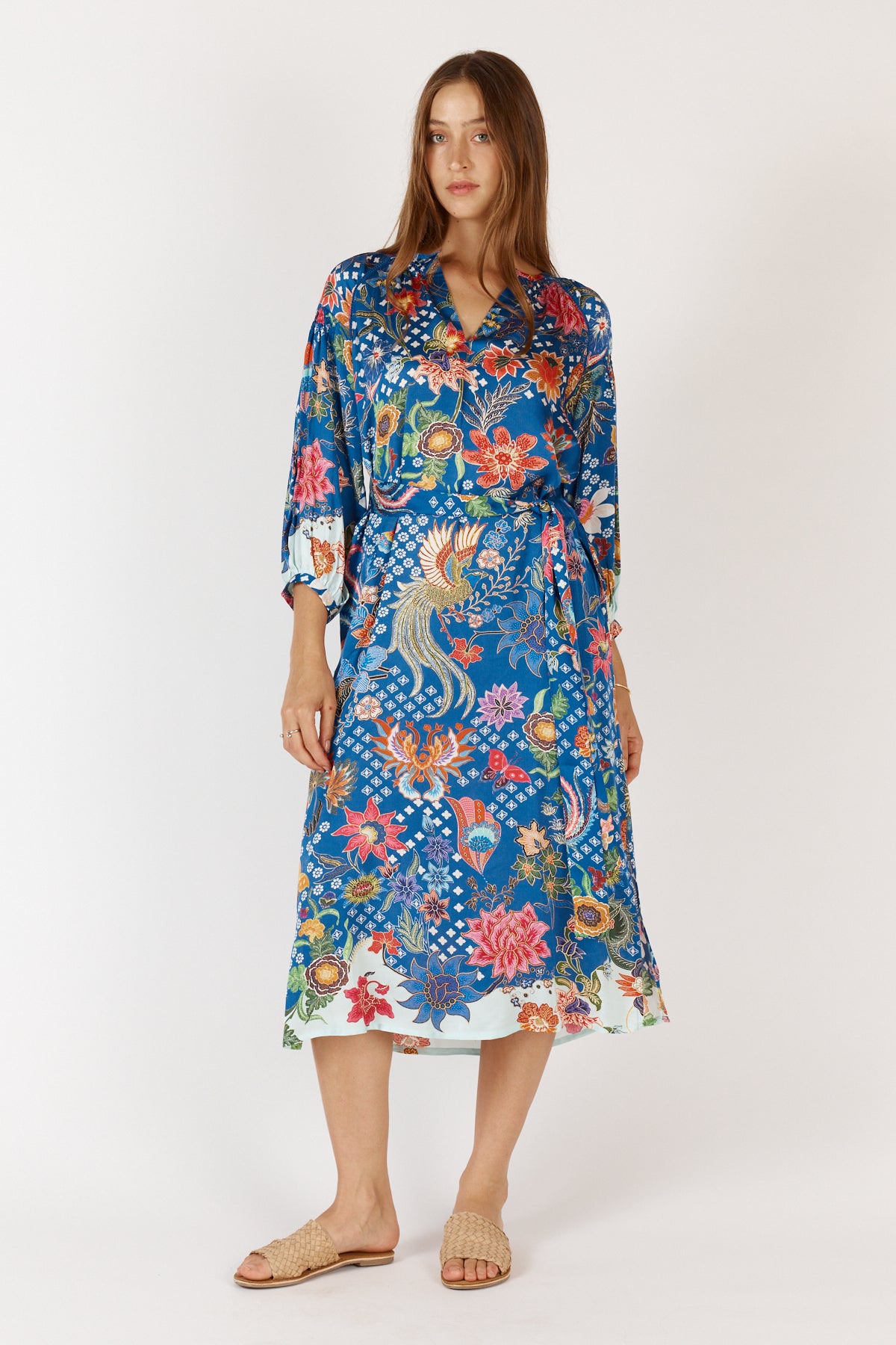 Woman weraing floral blue Toscana Satin Midi Dress with long sleeves, collar and tie waist.