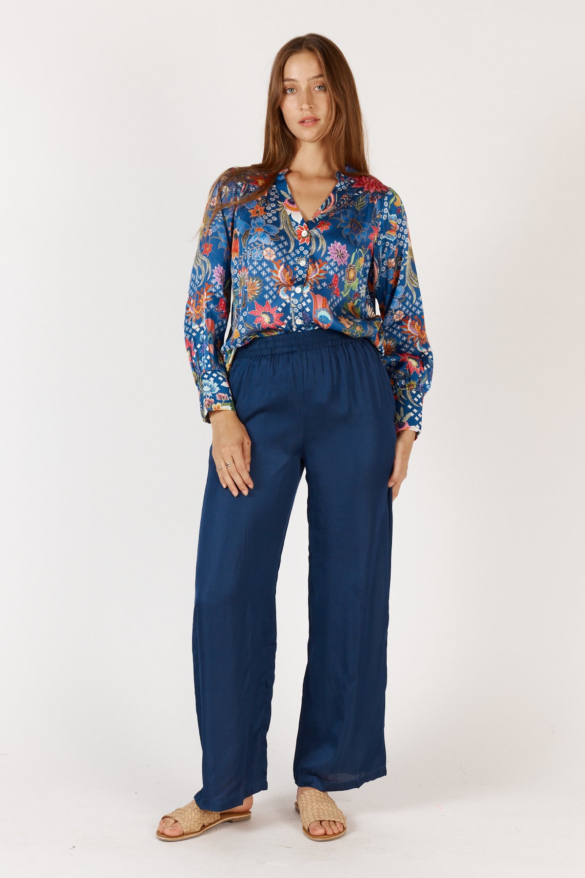 Woman wearing a colorful floral Toscana long Sleeve Shirt with long sleeves and grandpa collar by Rubyyaya.