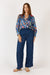 Woman wearing a colorful floral Toscana long Sleeve Shirt with long sleeves and grandpa collar by Rubyyaya.