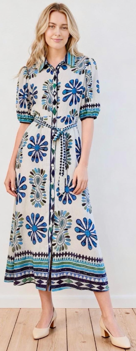Woman wearing below knee shirt dress in blue and white floral dress by Sambara.