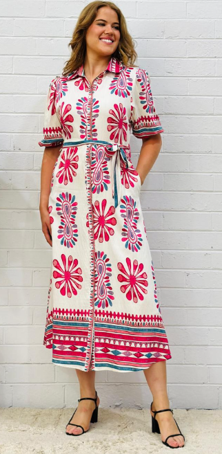Bright pink and white shirt dress with tie waist, below knee length, shown on woman.
