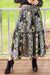 Woman wearing Cienna's Myra Boho Tiered Maxi Skirt in Black Floral Multi with tie waist.