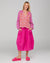 Model wearing a patterned cotton Fleetwood Top in Spliced Naples a pink, white and red print with long sleeves a v-neck and straight hem.