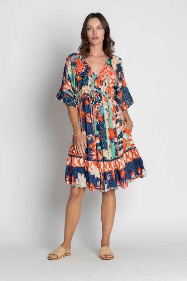 Woman wearing the Oriental inspired Wazuka Tie Midi Dress with V-Neck Short sleeves and a ruffle hem by LulaSoul.