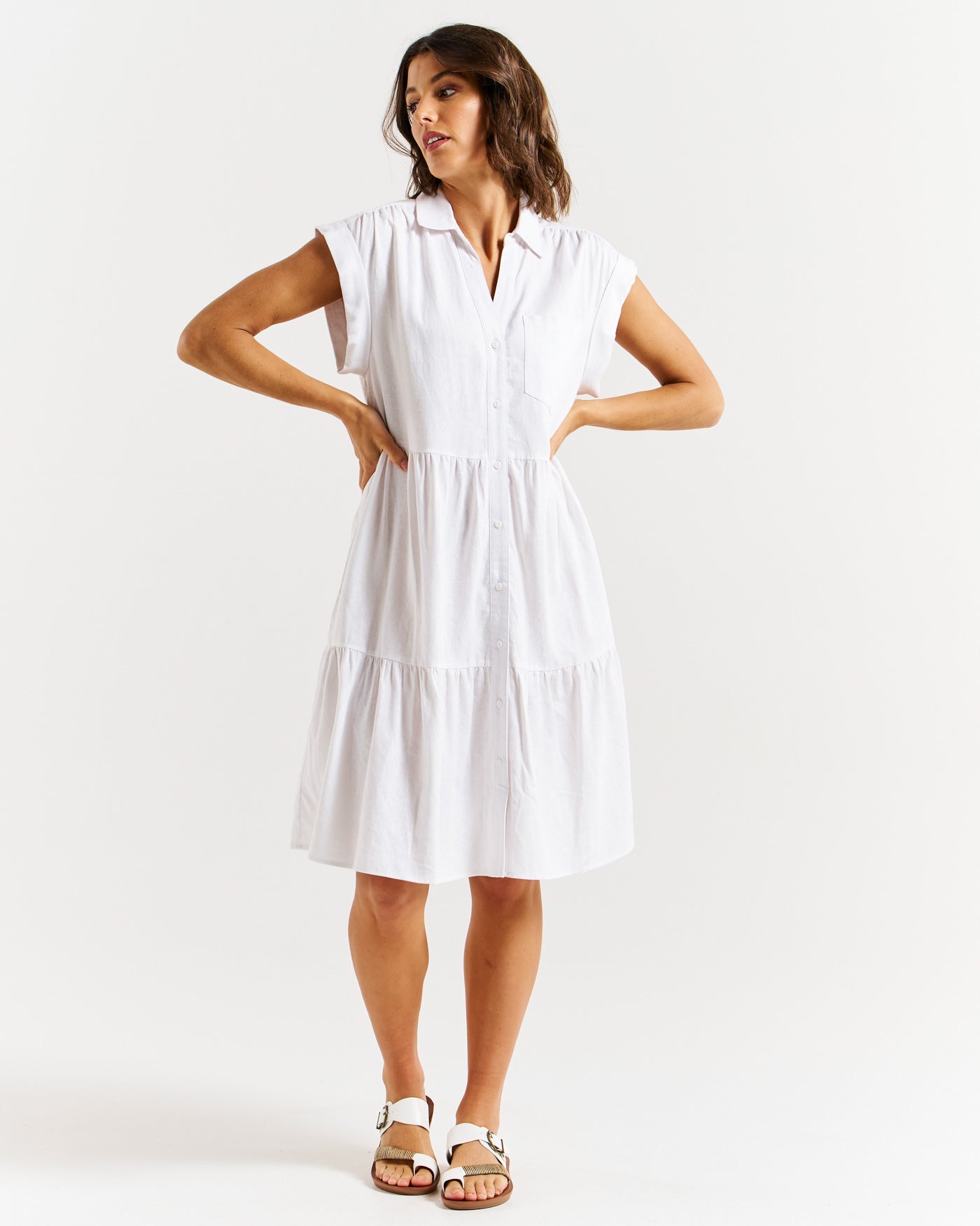 Model wearing Betty Basics Zurich tiered midi dress in white.